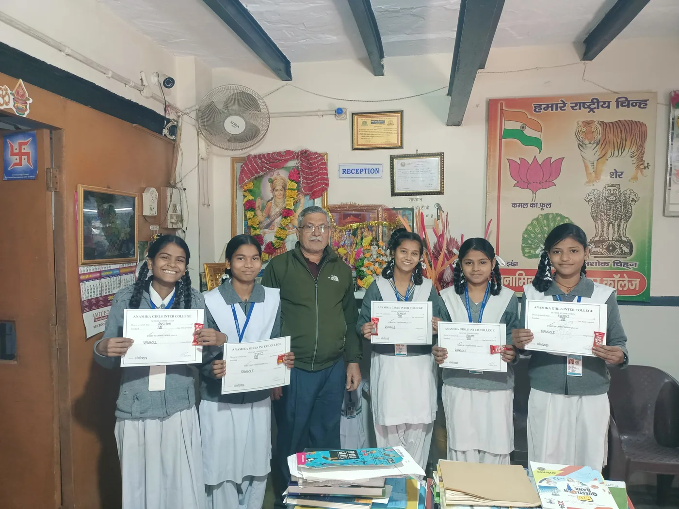 Rangoli competition winners with certificates